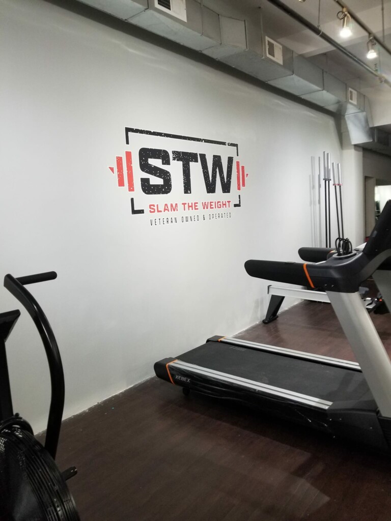 A gym wall with the logo 