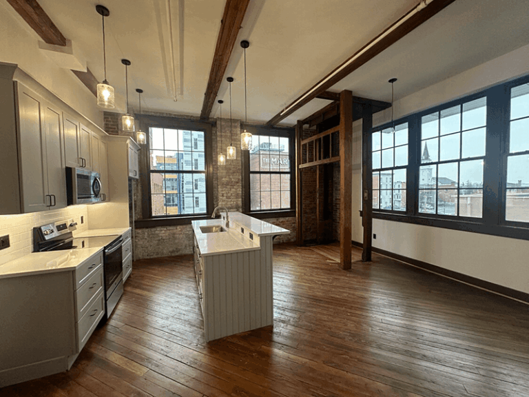 Photo of a loft-style apartment with central kitchen island.